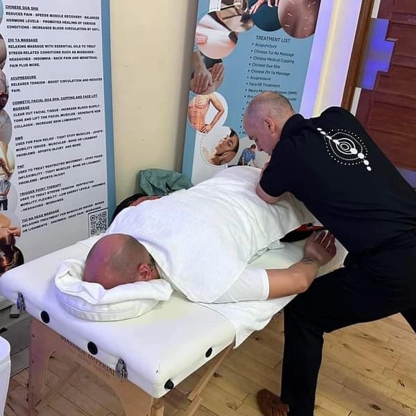 Lee providing hands-on treatment to a client at the clinic